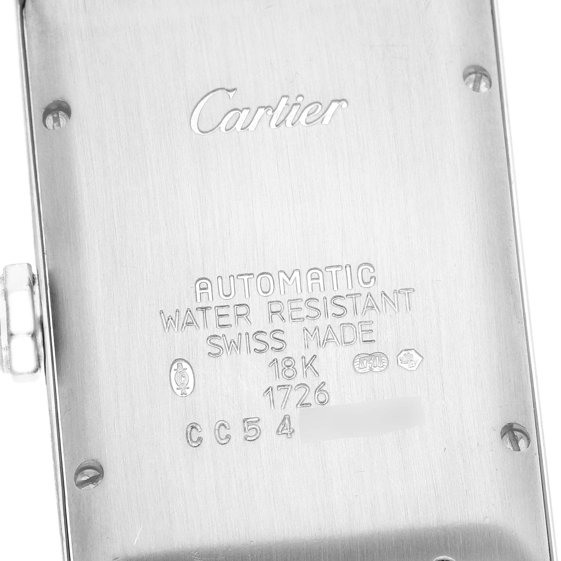 The image shows the back case of a Tank Americaine model by Cartier, displaying its engraving and screws.