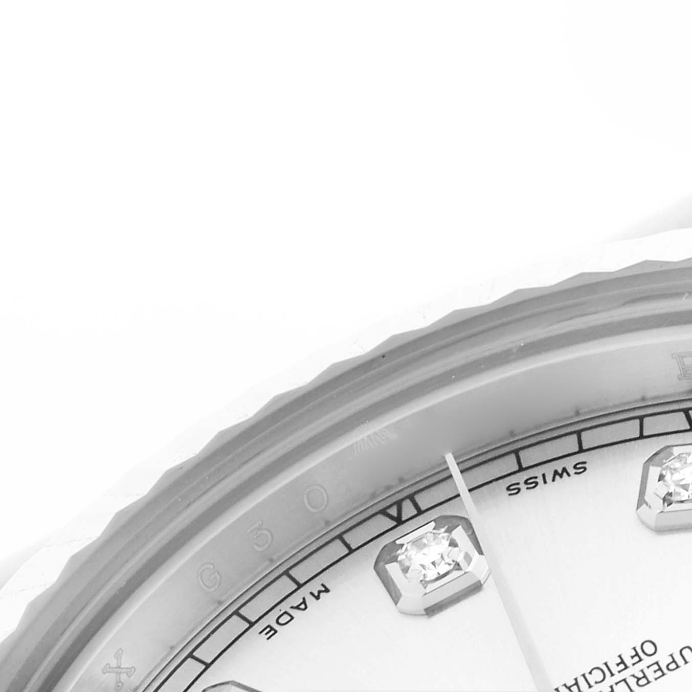 The image shows a close-up of the Rolex Datejust 41 116334 Men's Stainless Steel Silver Dial 116334 Men's Stainless Steel Silver Dial's dial and bezel, highlighting diamond hour markers and part of the minute hand.