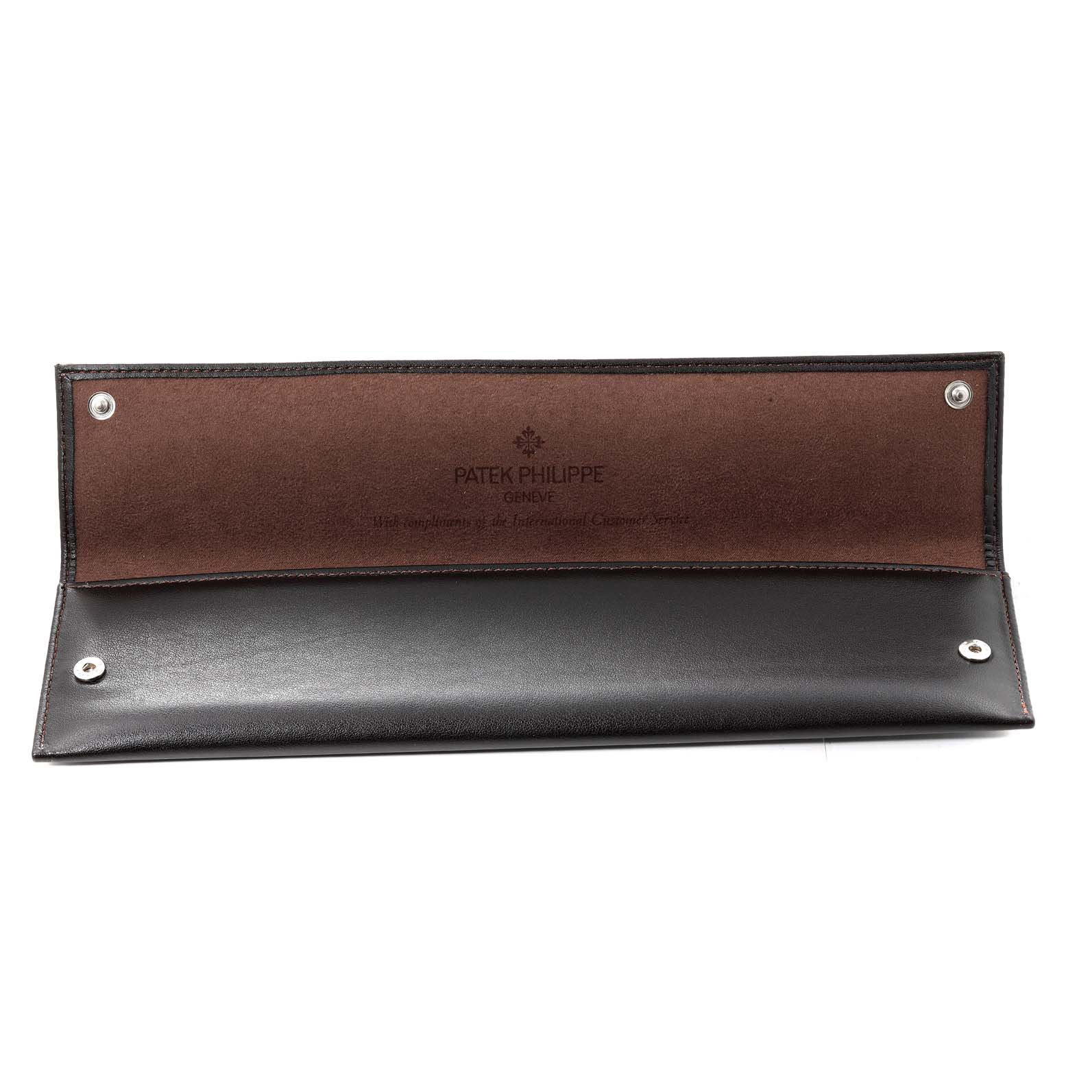 The image shows an open leather pouch accessory for the Calatrava model by Patek Philippe.