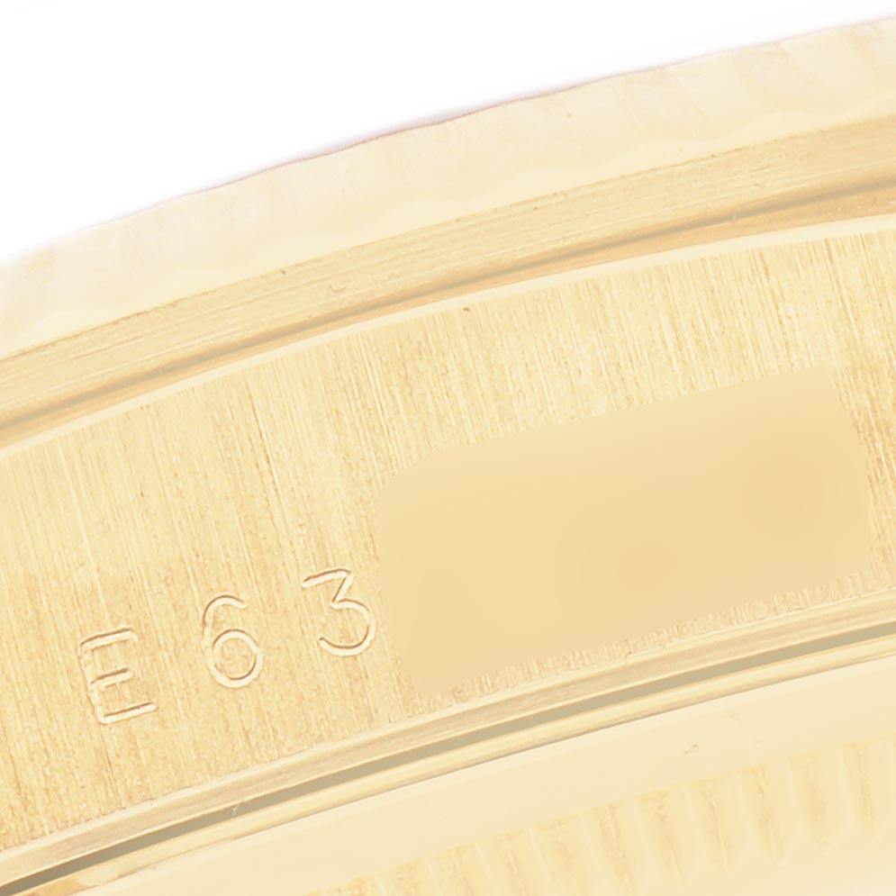 The image shows a close-up of the engraved serial number on a Rolex President 18238 Men's Yellow Gold Champagne Dial 18238 Men's Yellow Gold Champagne Dial model watch.