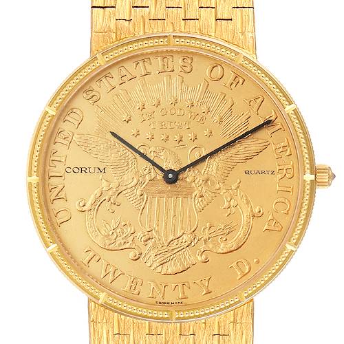 The image shows a Corum Coin Watch 1875  Men's Yellow Gold Black Dial 1875  Men's Yellow Gold Black Dial model from the front, highlighting its detailed dial and part of the golden band.