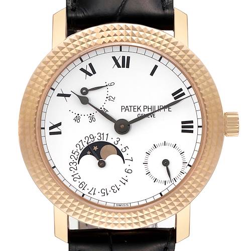 The image shows a close-up of the Patek Philippe Calatrava 5057R Men's Rose Gold White Dial 5057R Men's Rose Gold White Dial watch face, highlighting the dial, hands, date, and moon phase indicators.
