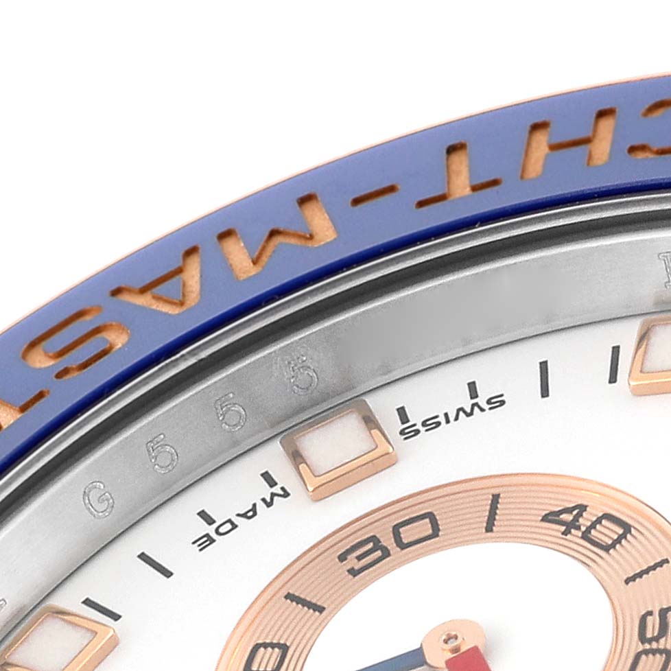 The image shows a close-up of the bezel and part of the dial of a Rolex Yacht-Master 116681 Men's Steel and Gold (two tone) White Dial 116681 Men's Steel and Gold (two tone) White Dial watch, highlighting its details and markings.