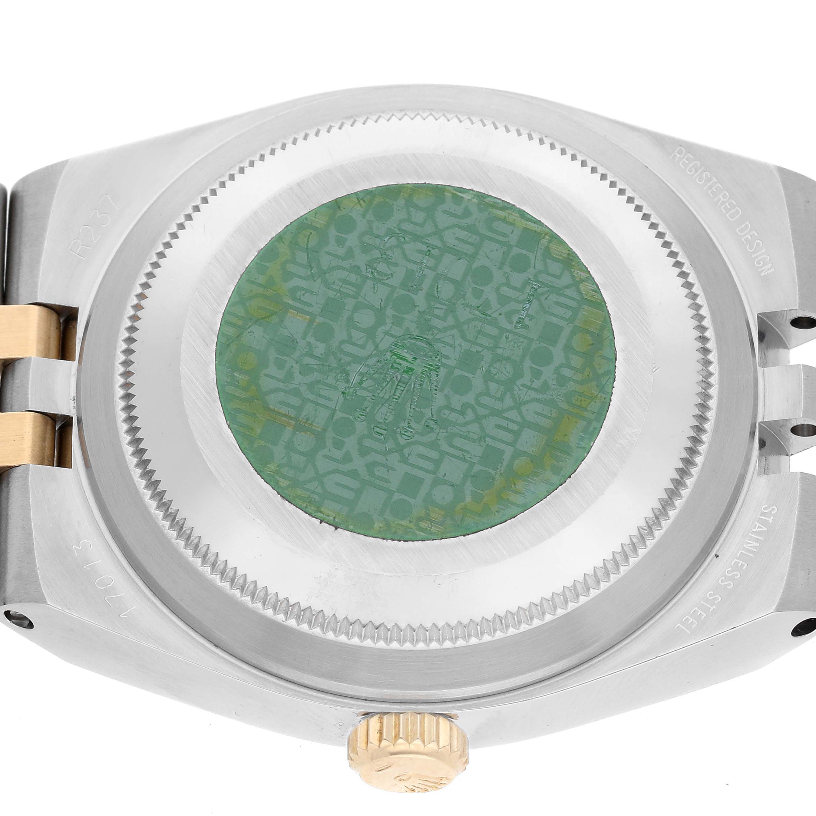 The image shows the case back of a Rolex Oysterquartz 17013 Men's Steel and Gold (two tone) Champagne Dial 17013 Men's Steel and Gold (two tone) Champagne Dial watch with its green sticker and part of the two-tone bracelet.