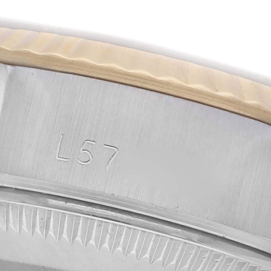 The image shows a close-up of the side of the Rolex Datejust 69173 Women's Steel and Gold (two tone) Champagne Dial 69173 Women's Steel and Gold (two tone) Champagne Dial's fluted bezel and engraved case with part of the model number.