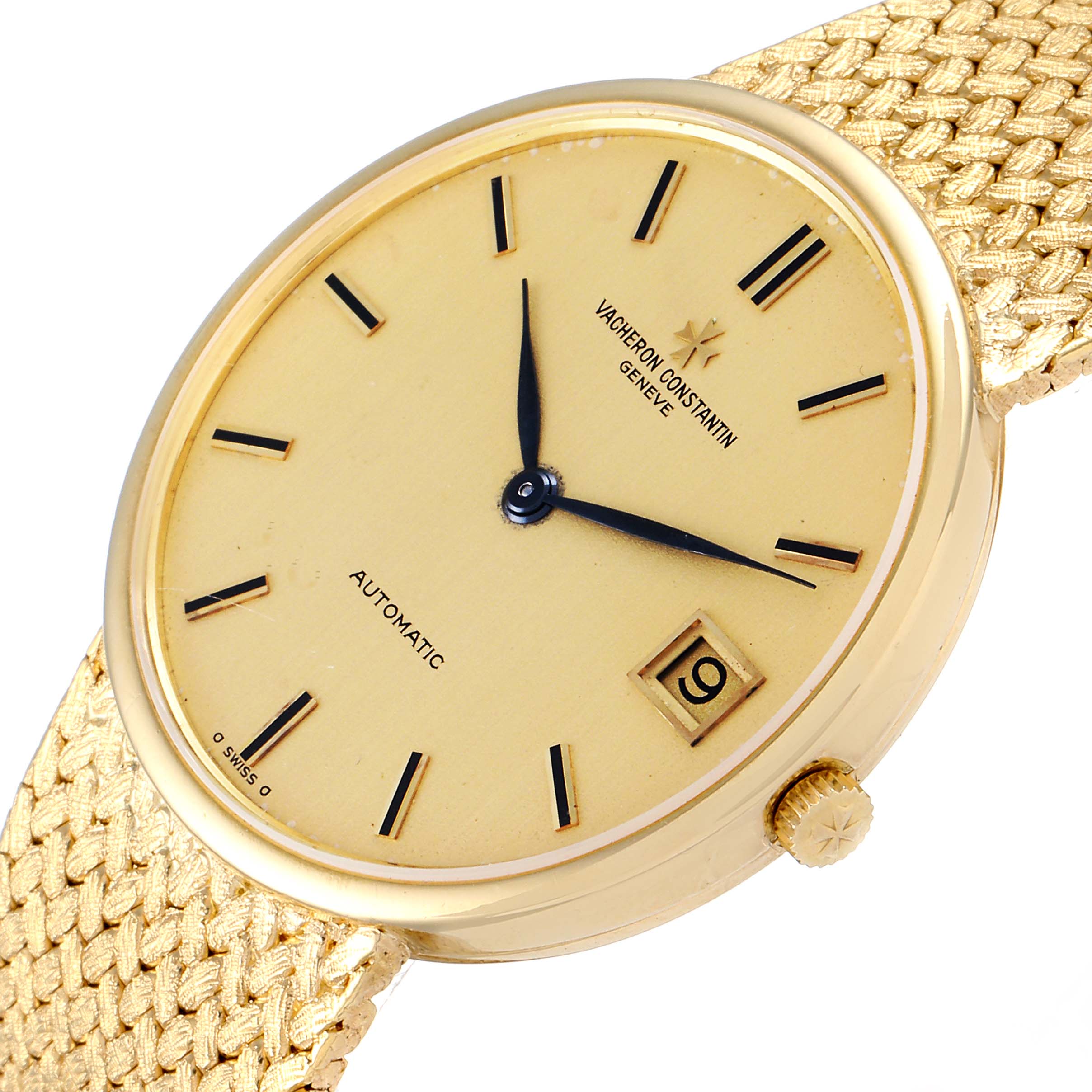 This image shows a Vacheron Constantin Patrimony 44012 Men's Yellow Gold Champagne Dial 44012 Men's Yellow Gold Champagne Dial watch at an oblique angle, highlighting its gold dial, hands, date window, and textured gold strap.