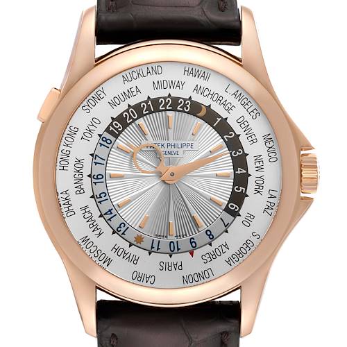 The image shows a frontal view of a Patek Philippe Complications 5130R-001 Men's Rose Gold Silver Dial 5130R-001 Men's Rose Gold Silver Dial watch, featuring a world time dial and a leather strap.