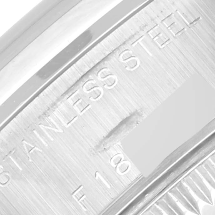 This close-up angle shows the engraved text "STAINLESS STEEL" on the side of a Rolex Date 79160 Women's Stainless Steel White Dial 79160 Women's Stainless Steel White Dial model watch case.