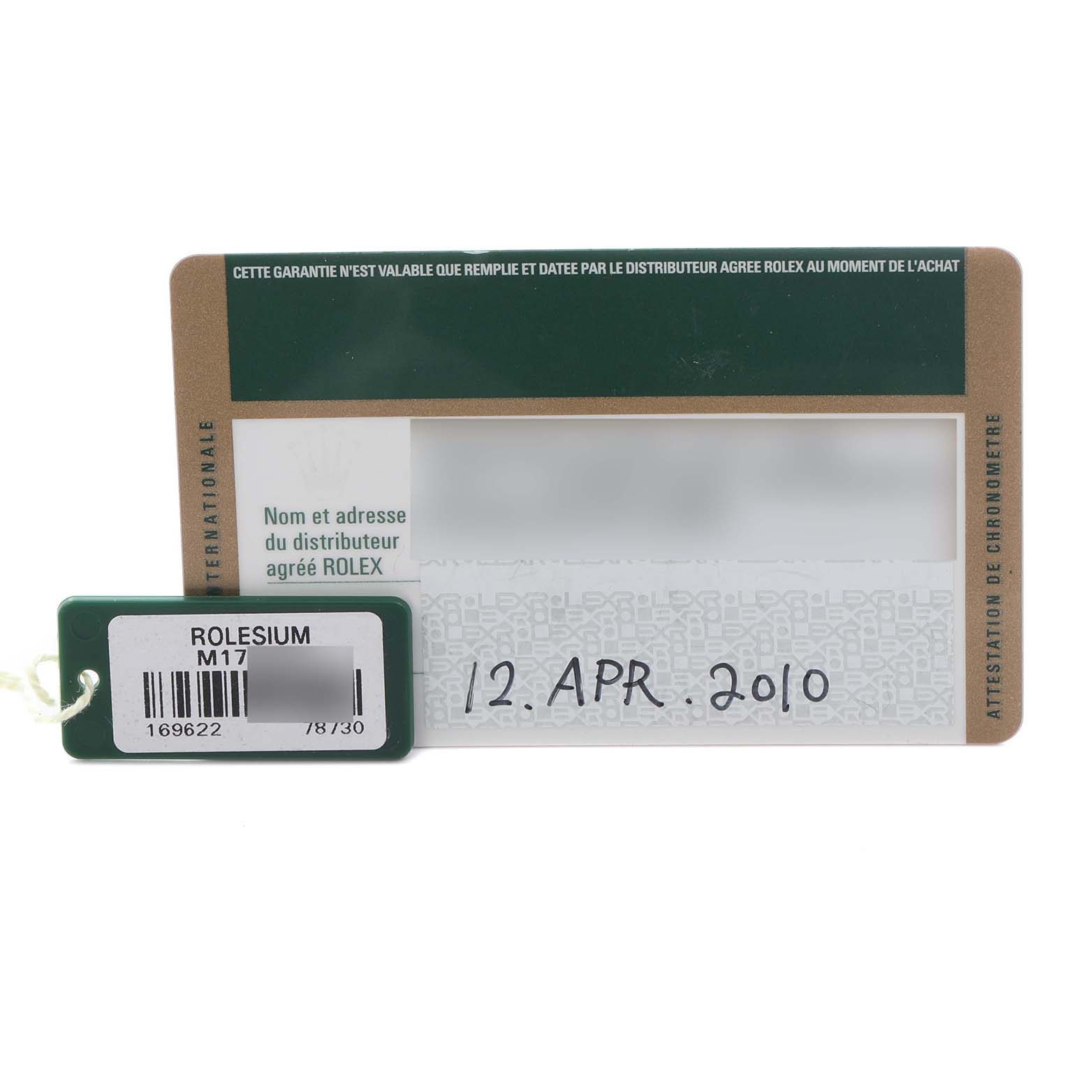 The image shows a guarantee card and a tag for the Rolex Yacht-Master 169622 Women's Stainless Steel Silver Dial 169622 Women's Stainless Steel Silver Dial watch, viewed from above.