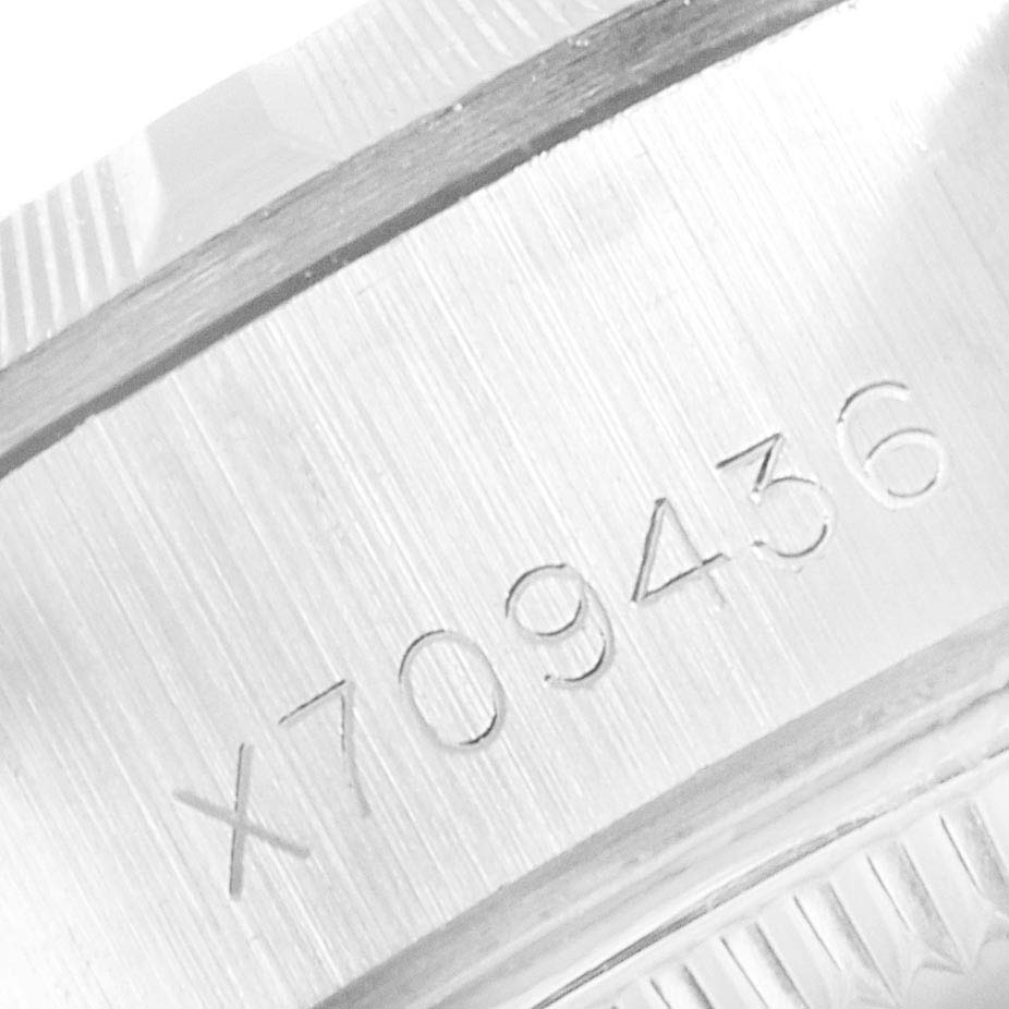 The image shows a close-up of the engraved serial number on the case of a Rolex Date 69190 Women's Stainless Steel White Dial 69190 Women's Stainless Steel White Dial watch.