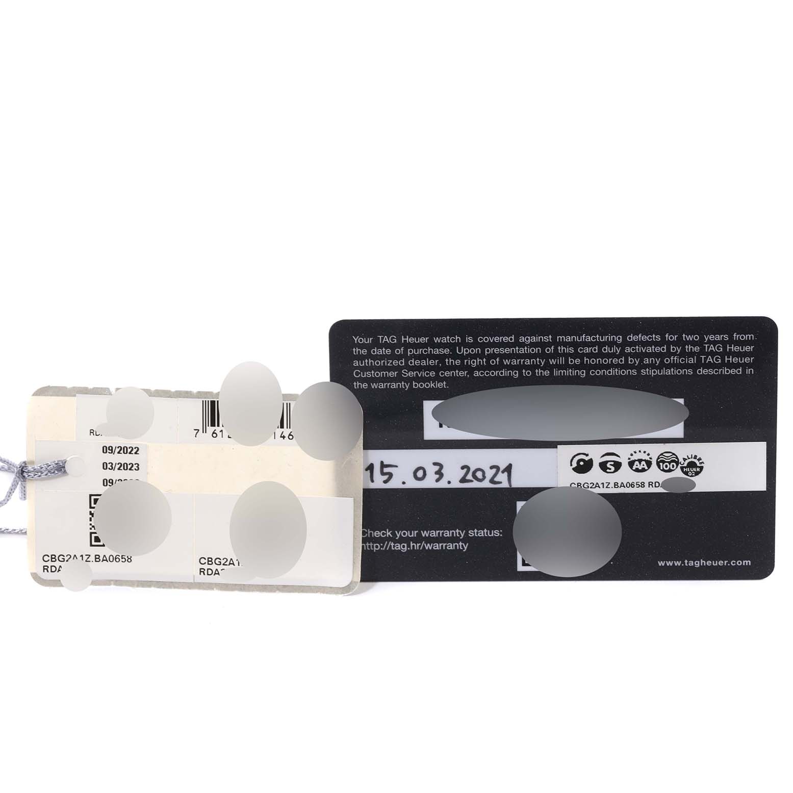 The image shows the warranty card and tags for a Tag Heuer Carrera CBG2A1Z.BA0658 Men's Stainless Steel Black Dial CBG2A1Z.BA0658 Men's Stainless Steel Black Dial model watch.