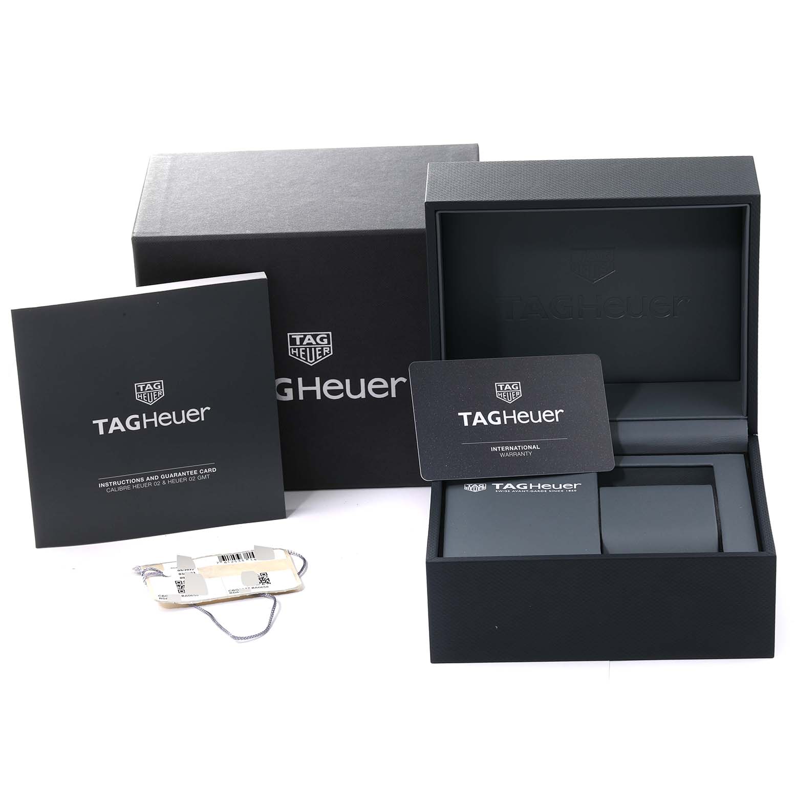 The image shows the packaging, instruction booklet, warranty card, and tags for a Tag Heuer Carrera CBG2A1Z.BA0658 Men's Stainless Steel Black Dial CBG2A1Z.BA0658 Men's Stainless Steel Black Dial watch.