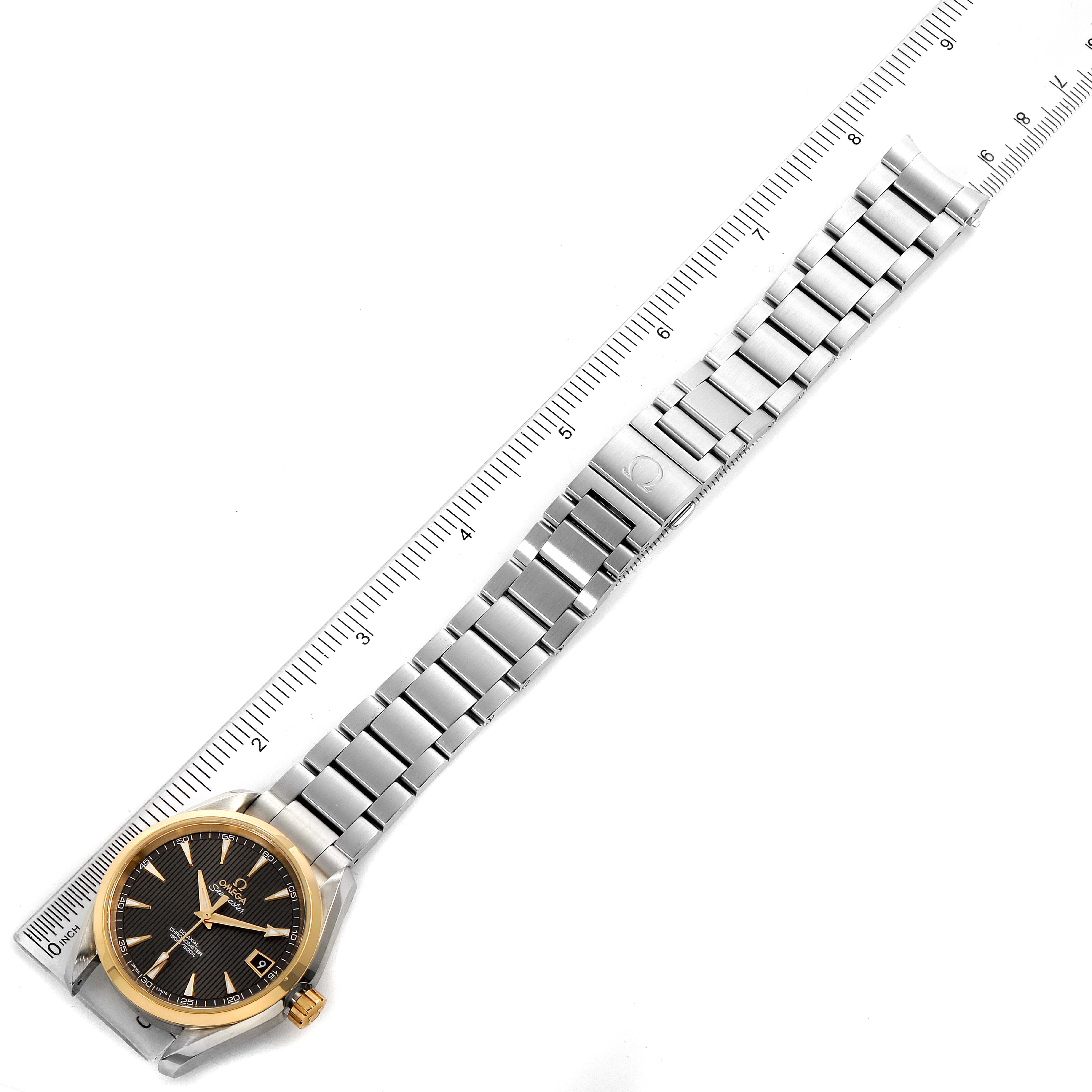 The image shows an Omega Aqua Terra 231.20.39.21.06.004 Men's Steel and Gold (two tone) Grey Dial 231.20.39.21.06.004 Men's Steel and Gold (two tone) Grey Dial watch laid flat with its bracelet extended beside a ruler for measurement.
