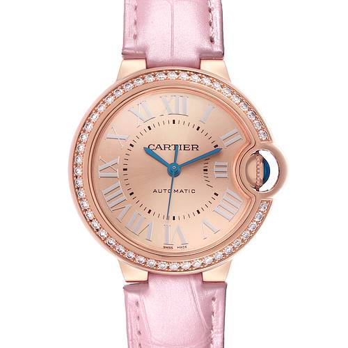 The Cartier Ballon Bleu WJBB0076 Women's Rose Gold Pink Dial watch is shown from the front, displaying its diamond bezel, pink strap, and blue hands.
