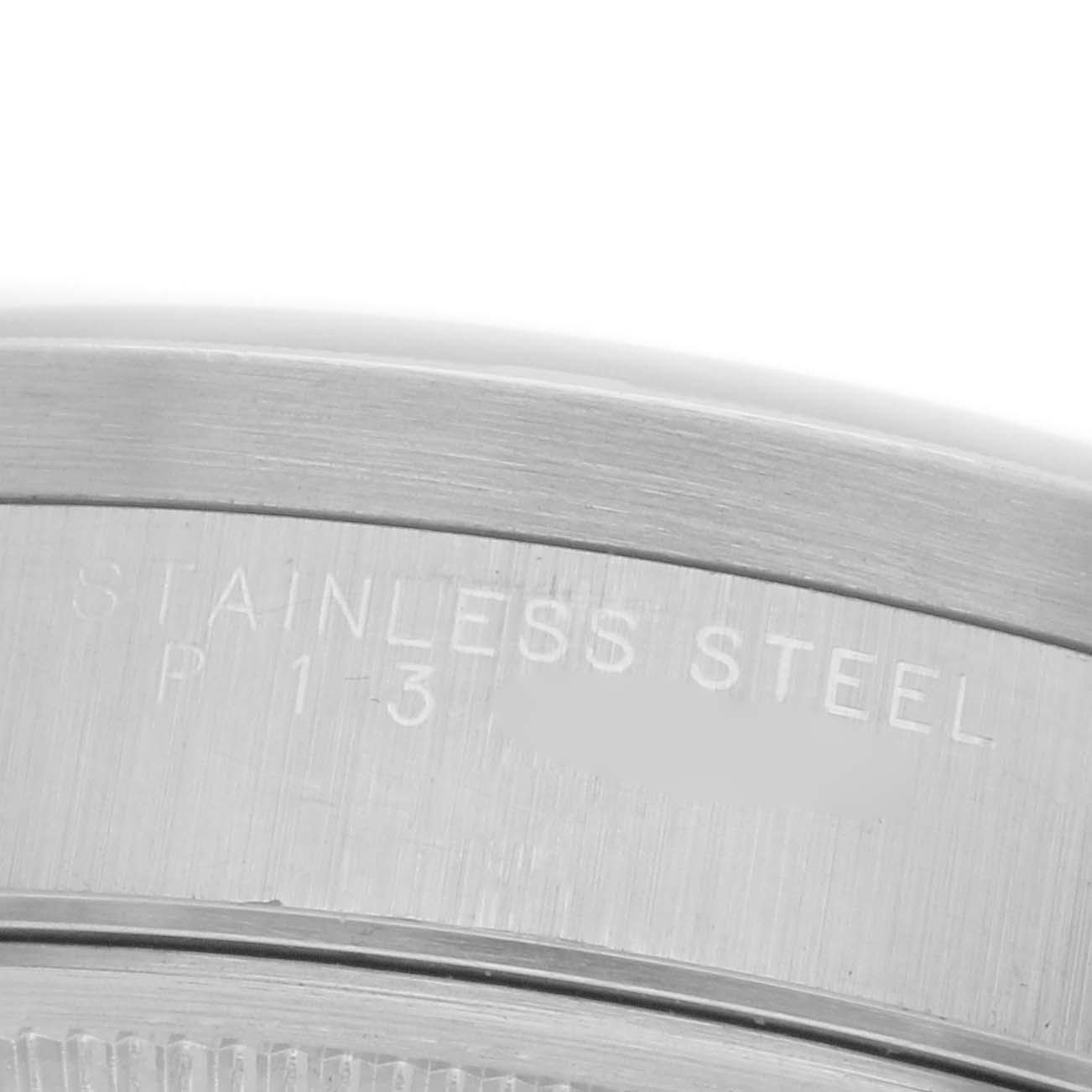 The image shows a close-up of the case back edge with engraving on a Rolex Date 15210 Men's Stainless Steel Blue Dial 15210 Men's Stainless Steel Blue Dial model watch.