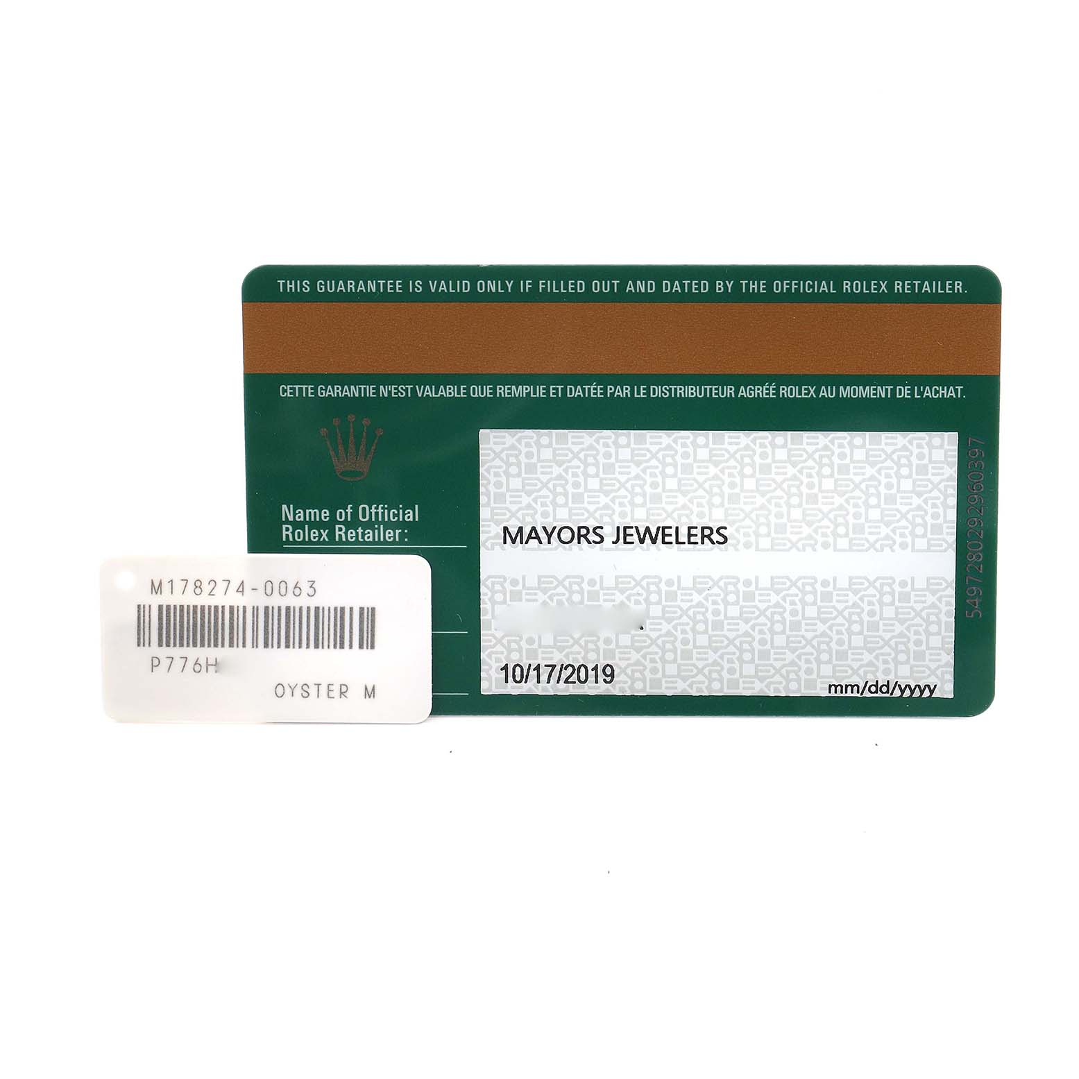 The image shows a Rolex Datejust warranty card and tag, displayed flat and directly from above.