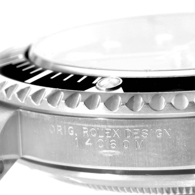 This image shows a side view of the Rolex Submariner 14060 Men's Stainless Steel Black Dial 14060 Men's Stainless Steel Black Dial, highlighting the bezel and engraved case with the model number 14060M.