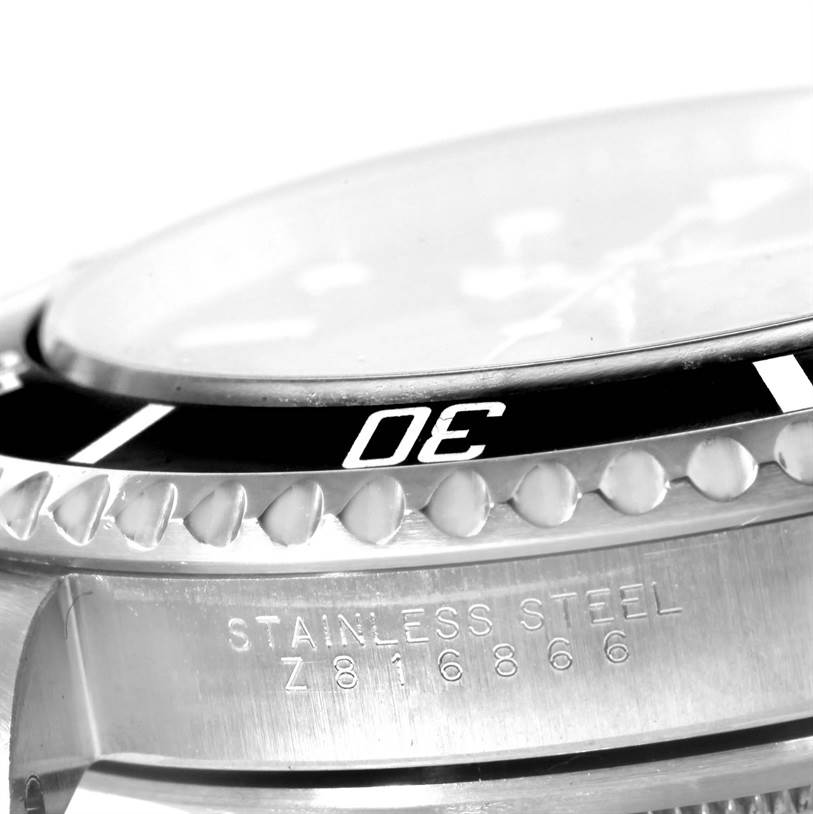 This image shows a close-up of the bezel and case side of a Rolex Submariner 14060 Men's Stainless Steel Black Dial 14060 Men's Stainless Steel Black Dial watch, featuring its model and stainless steel material engraving.