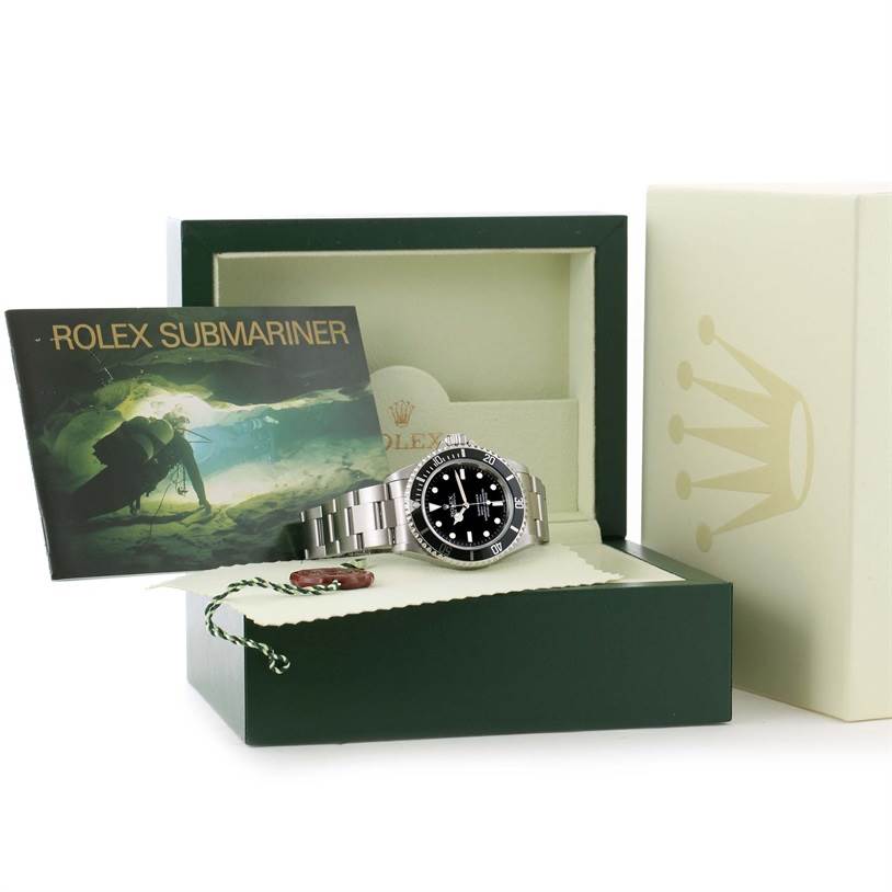 The image shows a Rolex Submariner 14060 Men's Stainless Steel Black Dial 14060 Men's Stainless Steel Black Dial watch in its open box, accompanied by its manual and tag, viewed from a front angle.