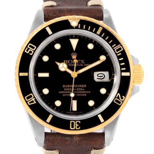 This is a front view of a Rolex Submariner 16803 Men's Steel and Gold (two tone) Black Dial 16803 Men's Steel and Gold (two tone) Black Dial watch, showcasing its black dial, gold accents, and brown leather strap.