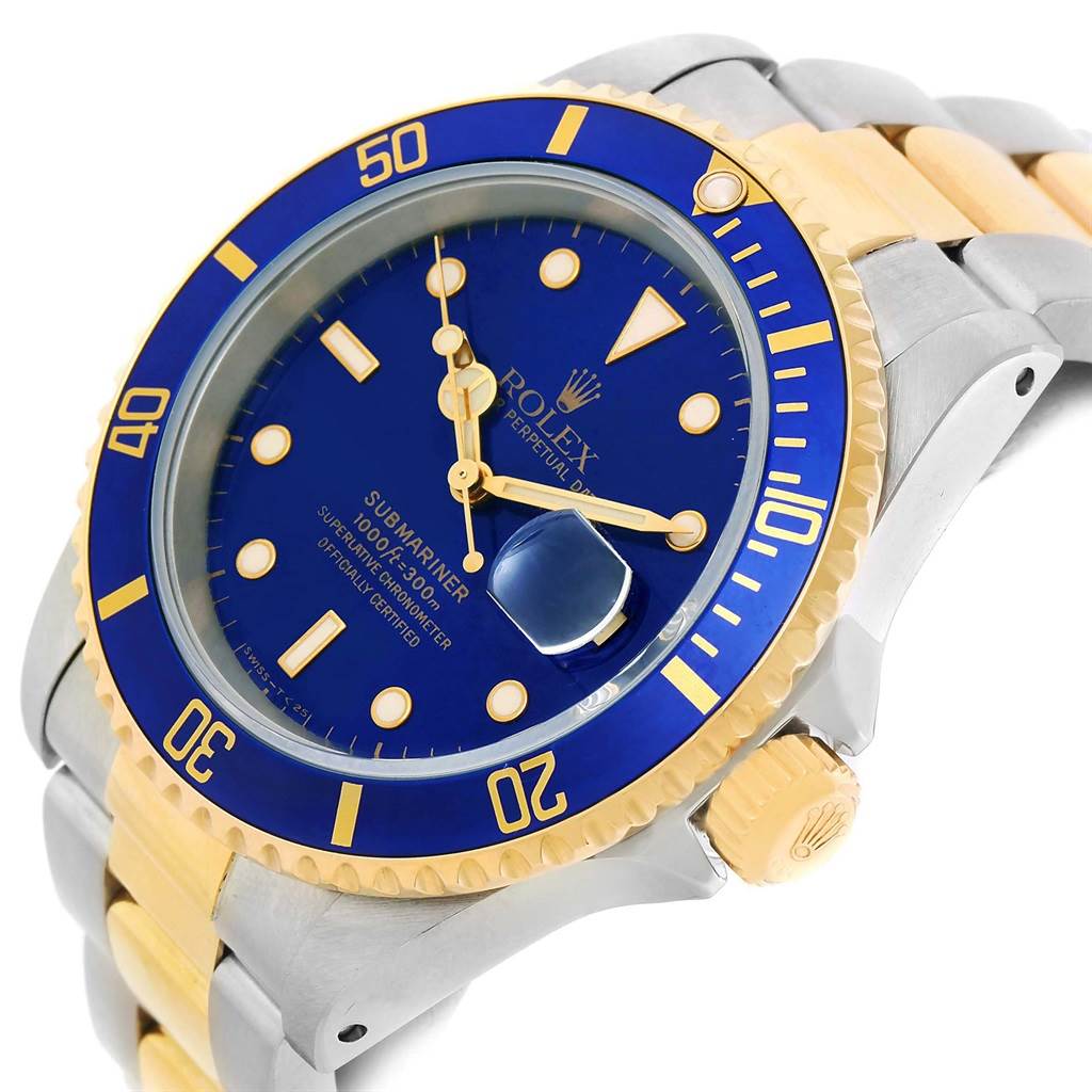The image shows a close-up, angled view of a Rolex Submariner 16613 Men's Steel and Gold (two tone) Blue Dial 16613 Men's Steel and Gold (two tone) Blue Dial, focusing on the watch face, bezel, crown, and part of the two-tone bracelet.