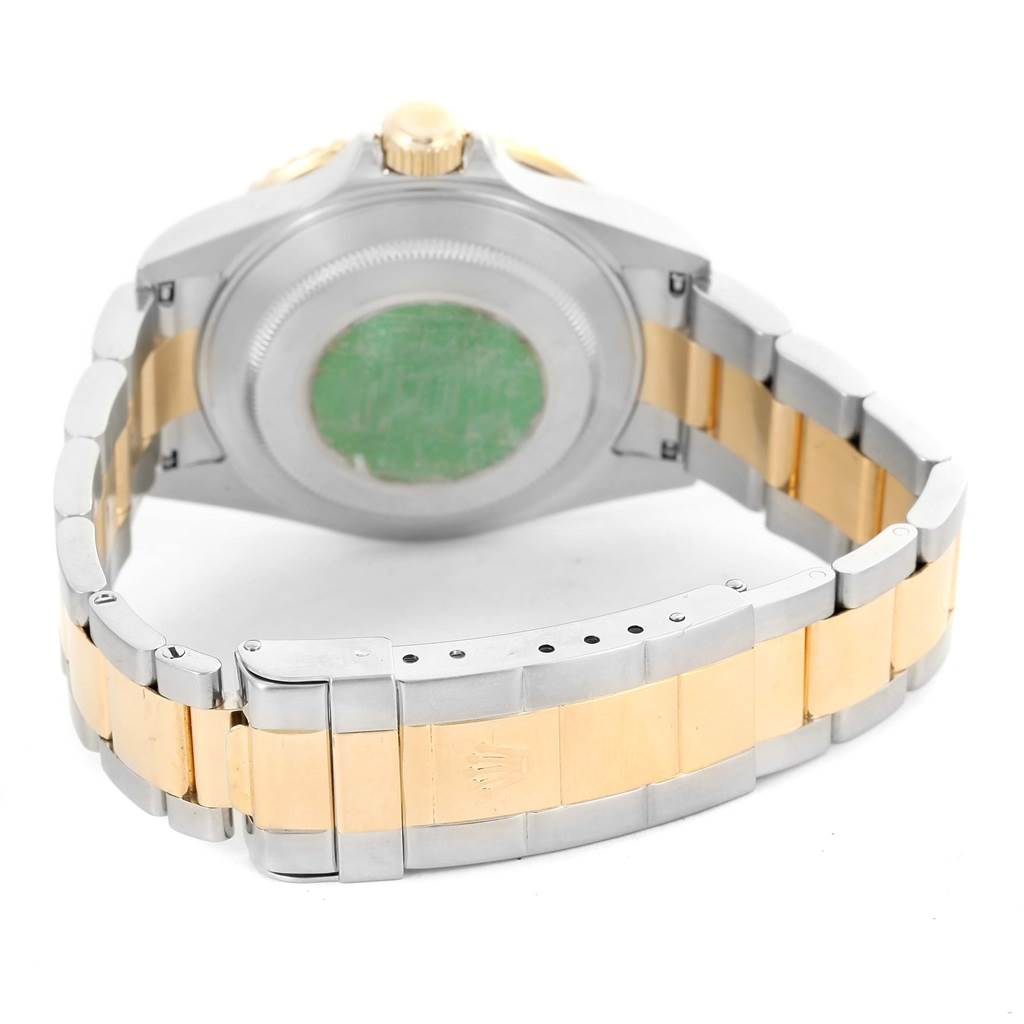 The image shows the back view of a Rolex Submariner 16613 Men's Steel and Gold (two tone) Blue Dial 16613 Men's Steel and Gold (two tone) Blue Dial watch, focusing on the case back and two-tone bracelet.