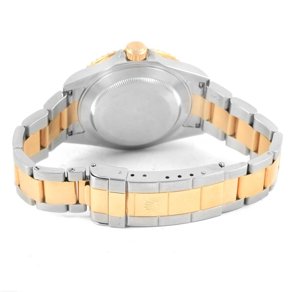 The image shows the back view of a Rolex Submariner 16613 Men's Steel and Gold (two tone) Grey Dial 16613 Men's Steel and Gold (two tone) Grey Dial, highlighting its bracelet and clasp.