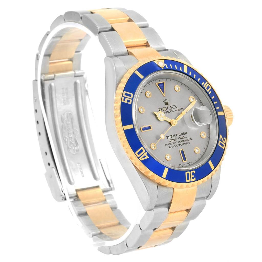This image shows a Rolex Submariner 16613 Men's Steel and Gold (two tone) Grey Dial 16613 Men's Steel and Gold (two tone) Grey Dial watch at a three-quarter angle, highlighting its bezel, dial, and two-tone bracelet.