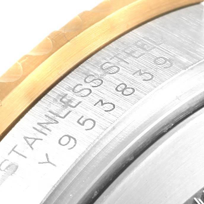 This close-up image shows the engraved stainless steel case back and part of the bezel of a Rolex Submariner 16613 Men's Steel and Gold (two tone) Grey Dial 16613 Men's Steel and Gold (two tone) Grey Dial watch.