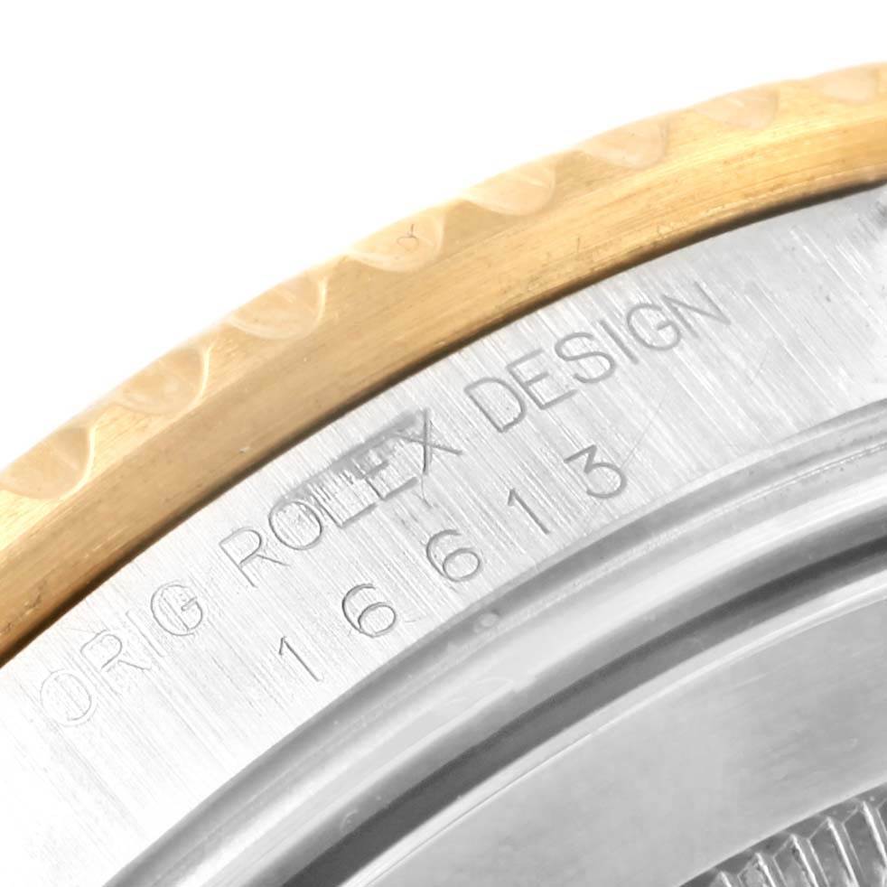 The image shows a close-up of the engraved case back of a Rolex Submariner 16613 Men's Steel and Gold (two tone) Champagne Dial 16613 Men's Steel and Gold (two tone) Champagne Dial model 16613, with part of the bezel visible.
