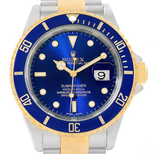 The image shows a close-up of a Rolex Submariner 16613 Men's Steel and Gold (two tone) Blue Dial 16613 Men's Steel and Gold (two tone) Blue Dial watch face with a blue dial and a gold and silver bezel.