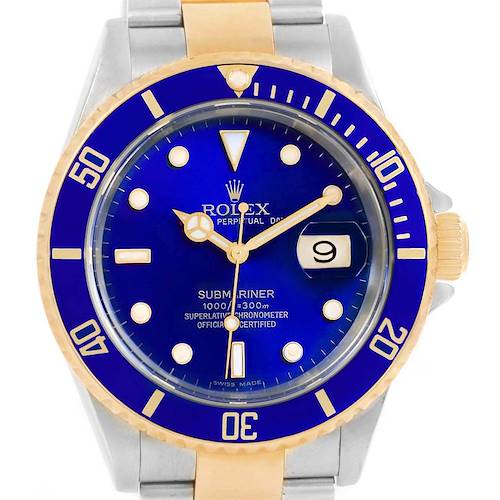 The image shows a close-up of the face of a Rolex Submariner 16613 Men's Steel and Gold (two tone) Blue Dial 16613 Men's Steel and Gold (two tone) Blue Dial watch with a blue dial and a two-tone bezel.