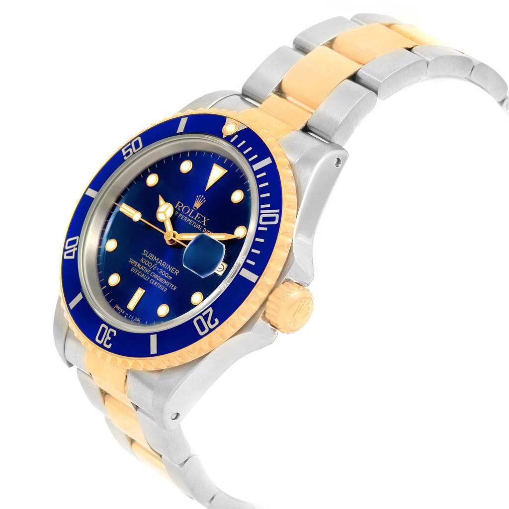 The image shows a Rolex Submariner 16613 Men's Steel and Gold (two tone) Blue Dial 16613 Men's Steel and Gold (two tone) Blue Dial watch at an angled view displaying its face, bezel, crown, and two-tone bracelet.