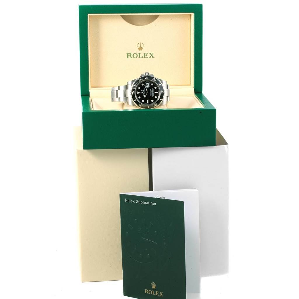 The Rolex Submariner 116610 Men's Stainless Steel Black Dial 116610 Men's Stainless Steel Black Dial is shown from a front angle, inside its green box, with accompanying paperwork in front.