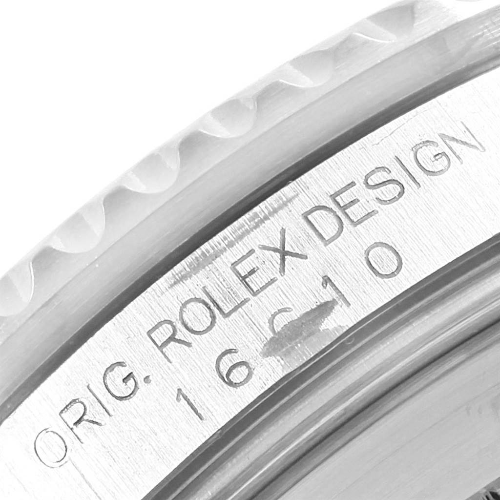 Close-up angle showing the engraved Rolex Submariner 16610 Men's Stainless Steel Black Dial 16610 Men's Stainless Steel Black Dial model "ORIG. ROLEX DESIGN 16610" on the inner bezel.