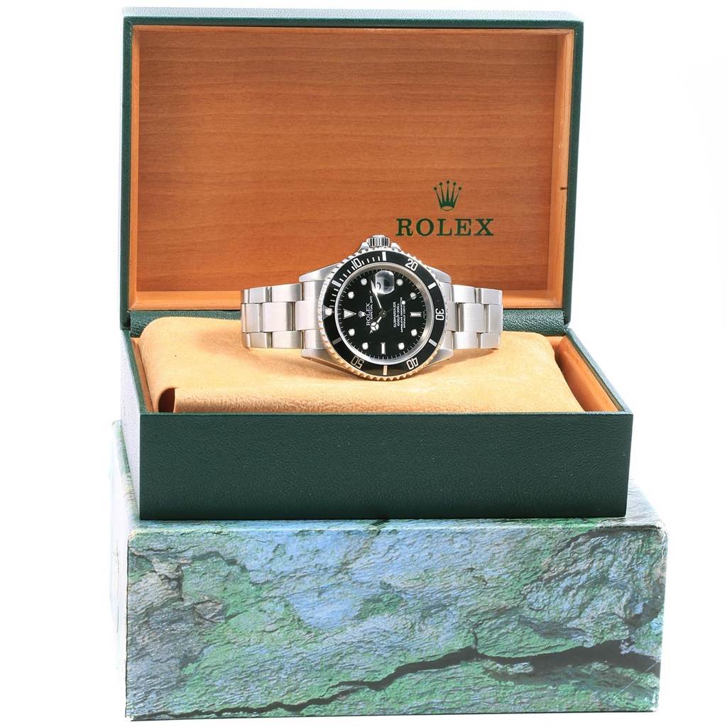The Rolex Submariner 16610 Men's Stainless Steel Black Dial 16610 Men's Stainless Steel Black Dial watch is shown from the front, inside its open box, with a clear view of the dial and bracelet.