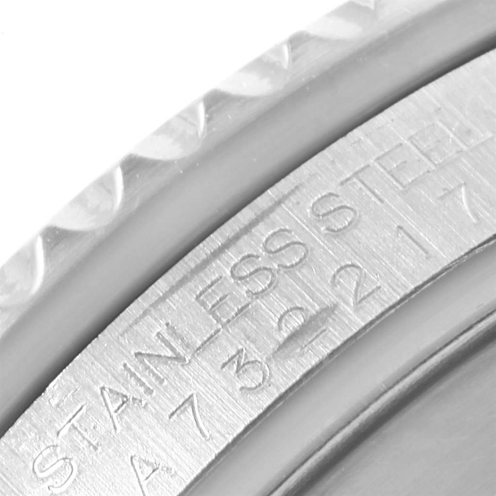 Close-up shot of the edge and inner bezel of a Rolex Submariner 16610 Men's Stainless Steel Black Dial 16610 Men's Stainless Steel Black Dial watch, showing 'STAINLESS STEEL' engraving.