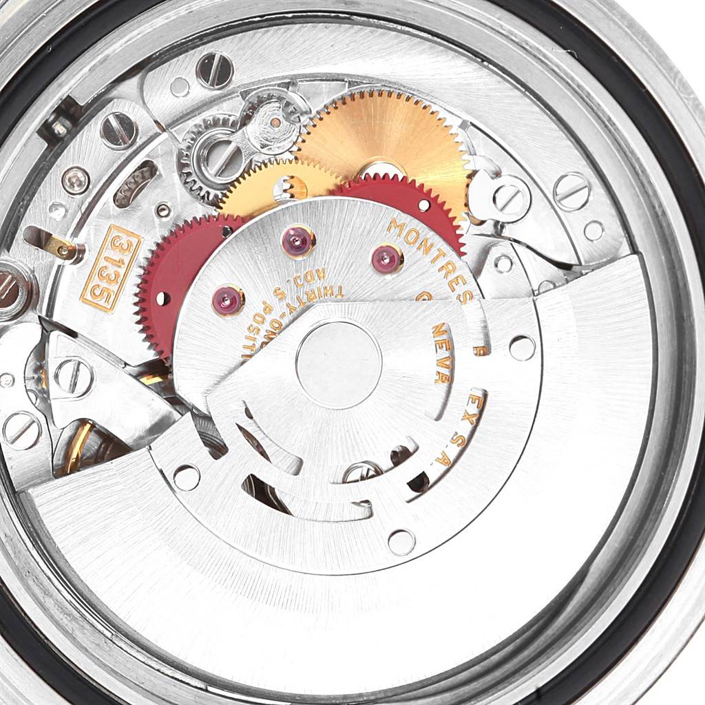 The image shows the internal mechanism and movement of a Rolex Submariner 16610 Men's Stainless Steel Black Dial 16610 Men's Stainless Steel Black Dial watch, including gears and the rotor.