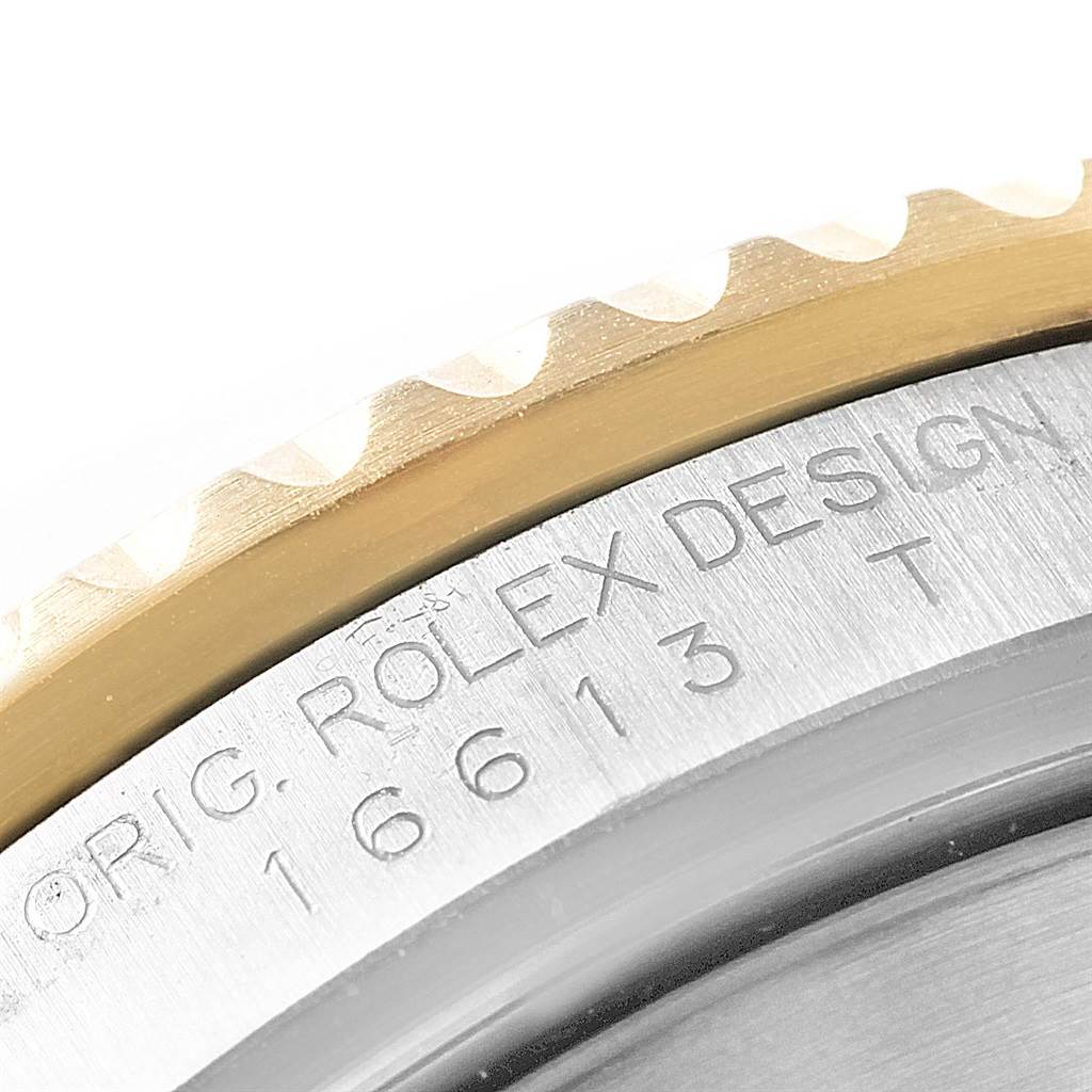 The image shows a close-up of the bezel and engraved serial number on a Rolex Submariner 16613 Men's Steel and Gold (two tone) Blue Dial 16613 Men's Steel and Gold (two tone) Blue Dial watch.