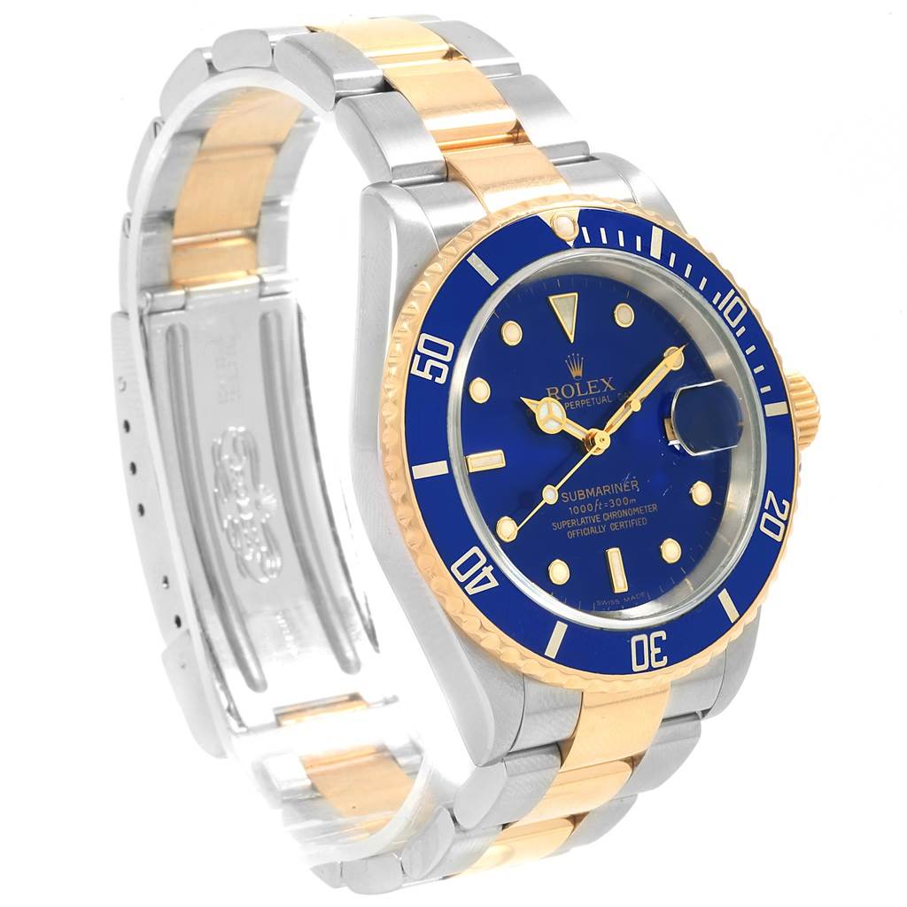 The image shows a Rolex Submariner 16613 Men's Steel and Gold (two tone) Blue Dial 16613 Men's Steel and Gold (two tone) Blue Dial watch at a left-side view angle, highlighting its blue dial, bezel, and two-tone bracelet.