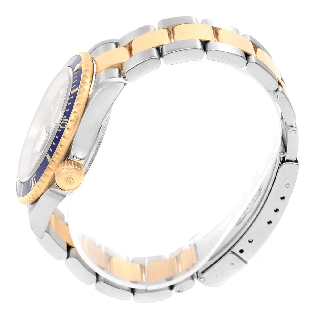 The image shows a side view of the Rolex Submariner 16613 Men's Steel and Gold (two tone) Blue Dial 16613 Men's Steel and Gold (two tone) Blue Dial watch, focusing on the band, bezel, and crown.