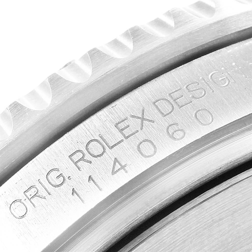 The image shows a close-up of the bezel and engraved case side of a Rolex Submariner 114060 Men's Stainless Steel Black Dial 114060 Men's Stainless Steel Black Dial watch.