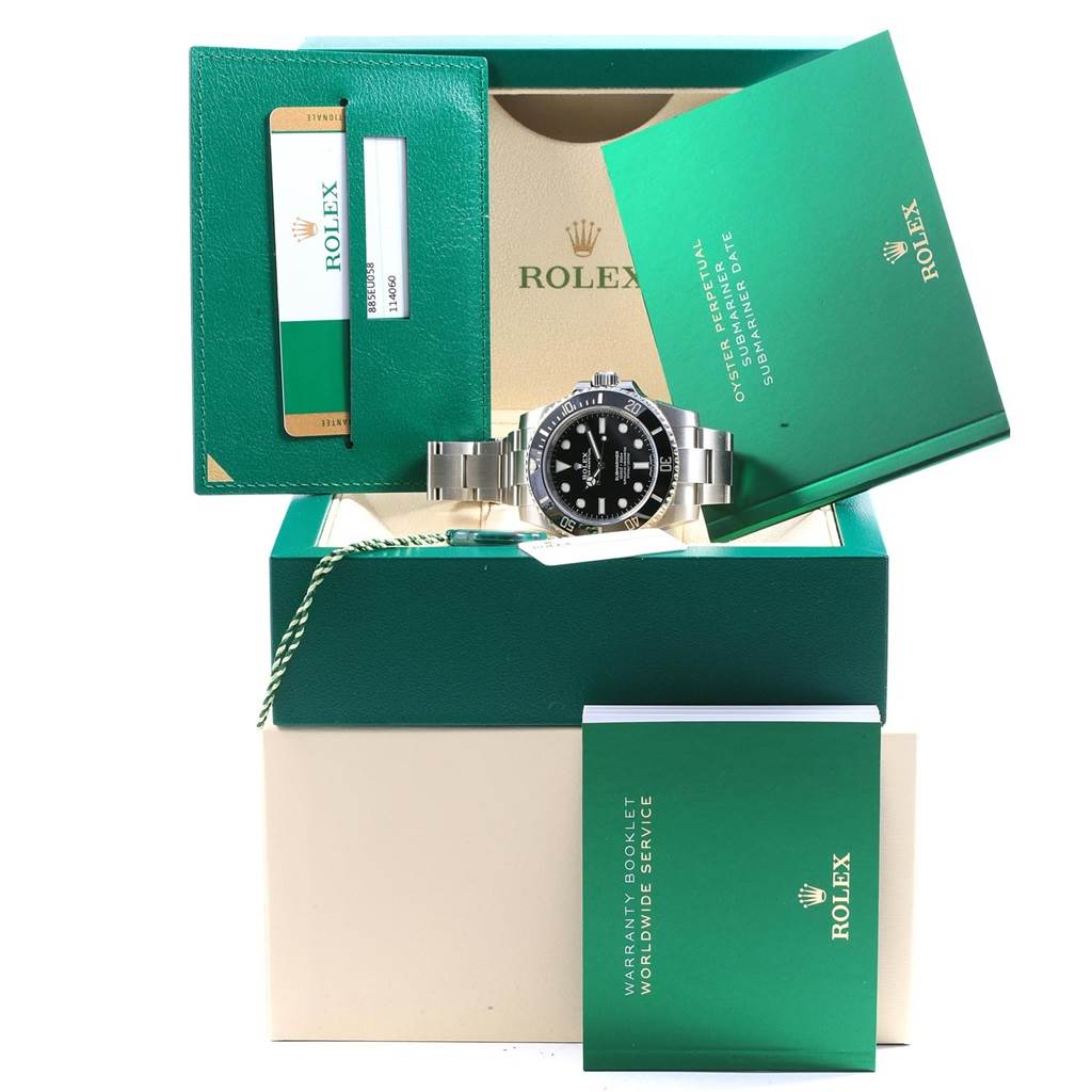 The image shows a Rolex Submariner 114060 Men's Stainless Steel Black Dial 114060 Men's Stainless Steel Black Dial watch with its box, warranty card, booklet, and accessories overall.