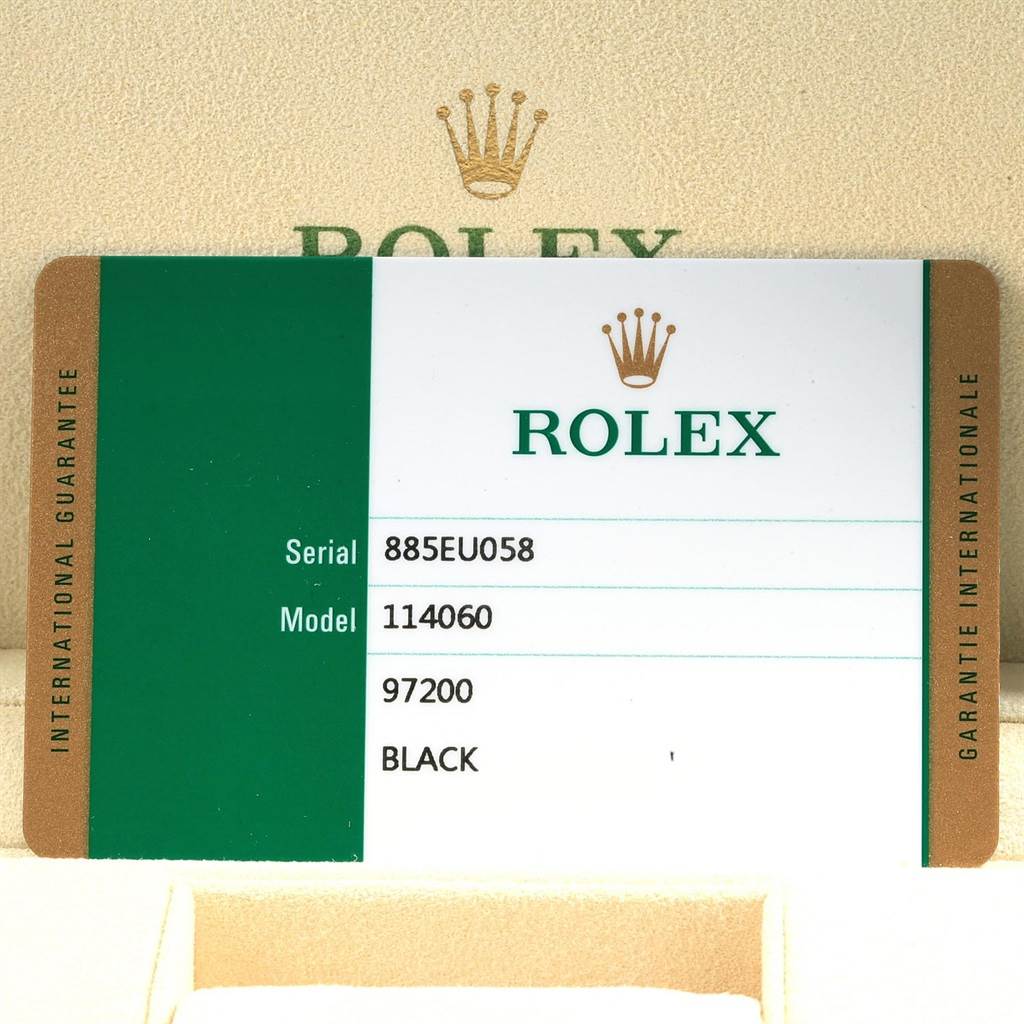 The image shows an international guarantee card with details for a Rolex Submariner 114060 Men's Stainless Steel Black Dial 114060 Men's Stainless Steel Black Dial model 114060.