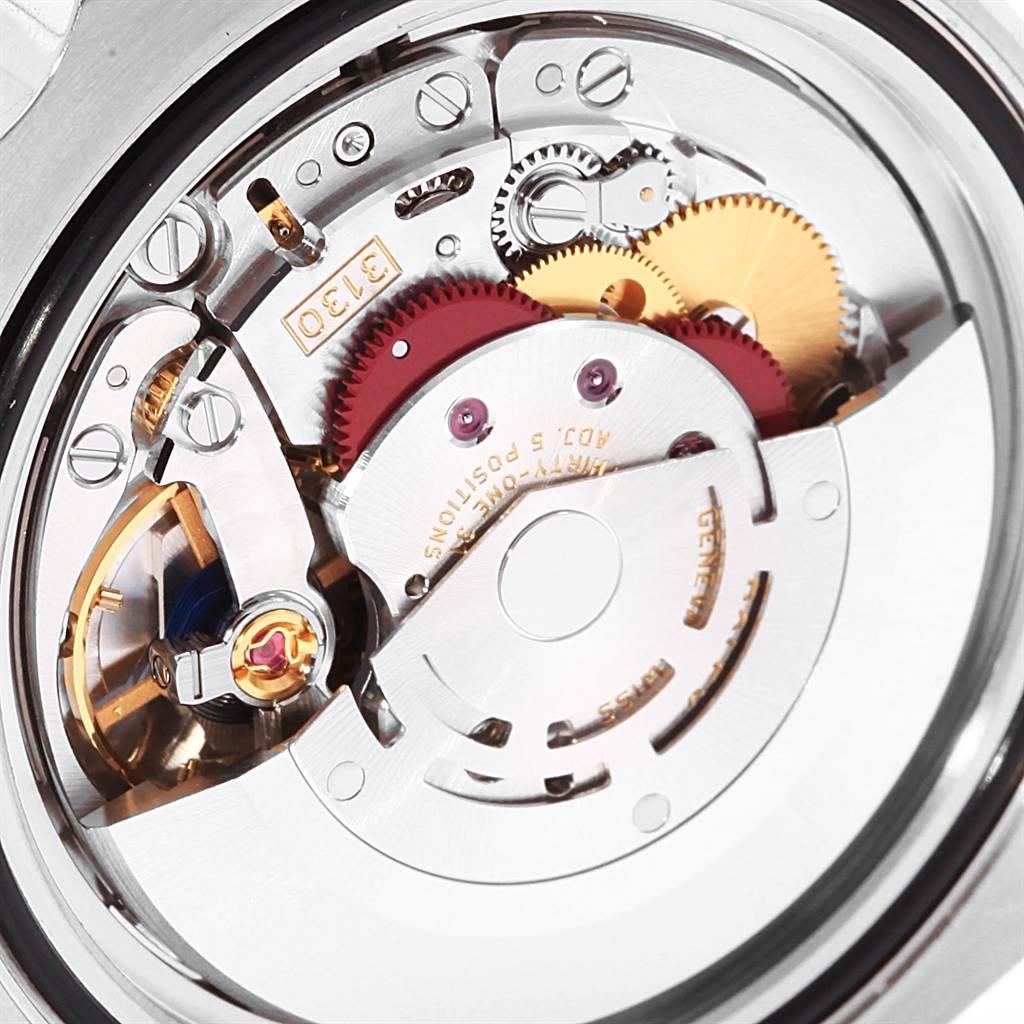 The image shows a close-up of the inner mechanical movement of a Rolex Submariner 114060 Men's Stainless Steel Black Dial 114060 Men's Stainless Steel Black Dial watch, highlighting the gears and components.