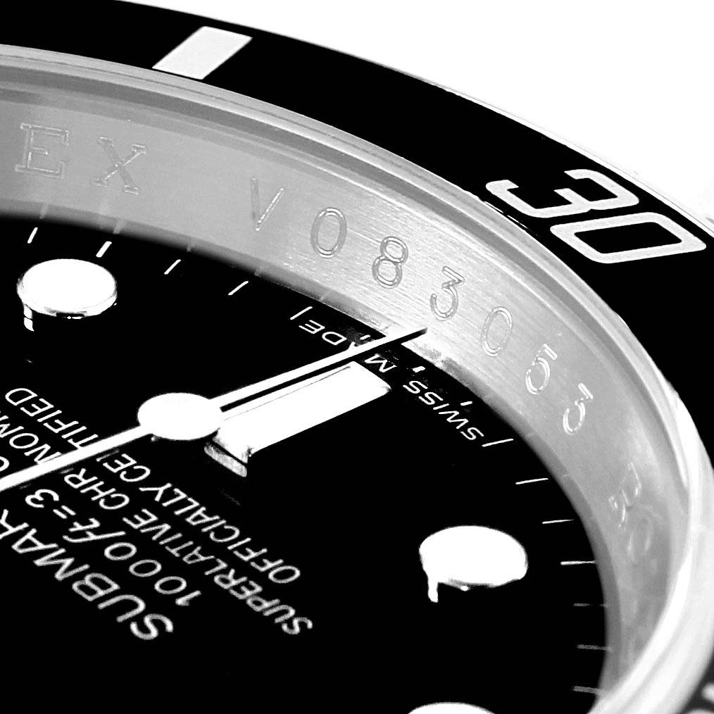 Close-up shot of an authentic Rolex Submariner 16610 Men's Stainless Steel Black Dial 16610 Men's Stainless Steel Black Dial model showing the dial, bezel, and part of the serial number.