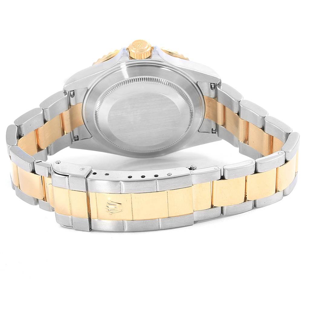 The image shows the back case, crown, and bracelet of the Rolex Submariner 16613 Men's Steel and Gold (two tone) Black Dial 16613 Men's Steel and Gold (two tone) Black Dial watch from a rear angle.