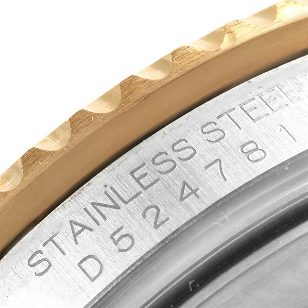 This close-up shows part of the stainless steel case back and the gold edge of the bezel of a Rolex Submariner 16613 Men's Steel and Gold (two tone) Black Dial 16613 Men's Steel and Gold (two tone) Black Dial watch.