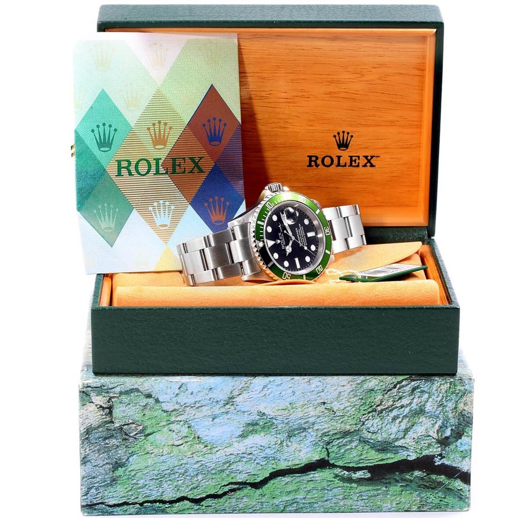 This image shows a Rolex Submariner 16610LV Men's Stainless Steel Black Dial 16610LV Men's Stainless Steel Black Dial watch at an angle with its packaging, displaying the watch, box, and certification booklet.