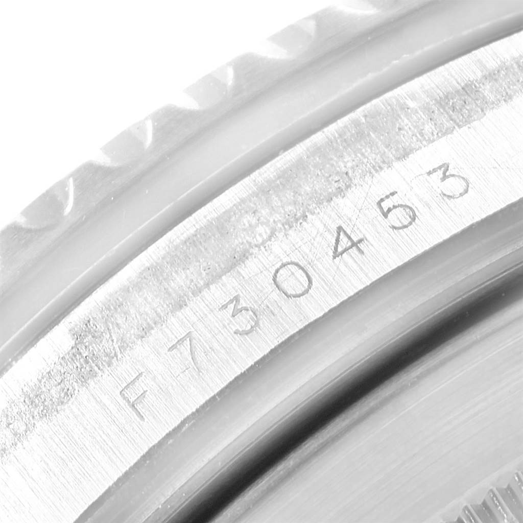 The image shows a close-up of the serial number and the casing edge of a Rolex Submariner 16610LV Men's Stainless Steel Black Dial 16610LV Men's Stainless Steel Black Dial watch.